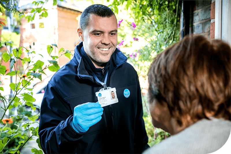A Thames Water employee shows a customer their ID on the doorstep