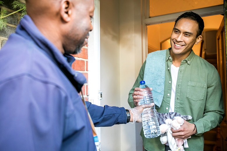 A Thames Water rep delivering bottled water to a priority services customer