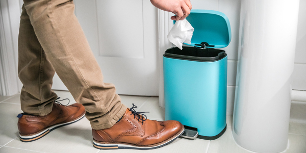 Customer throwing wipe into a bin