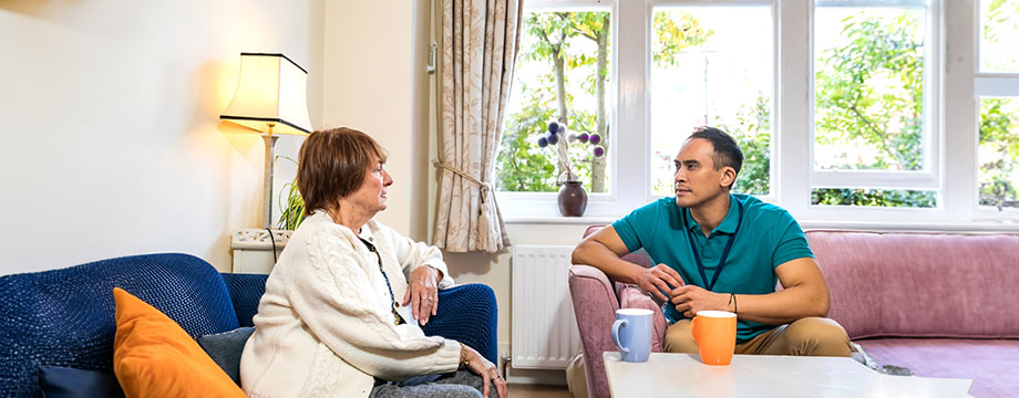 A woman and her carer have a cup of tea