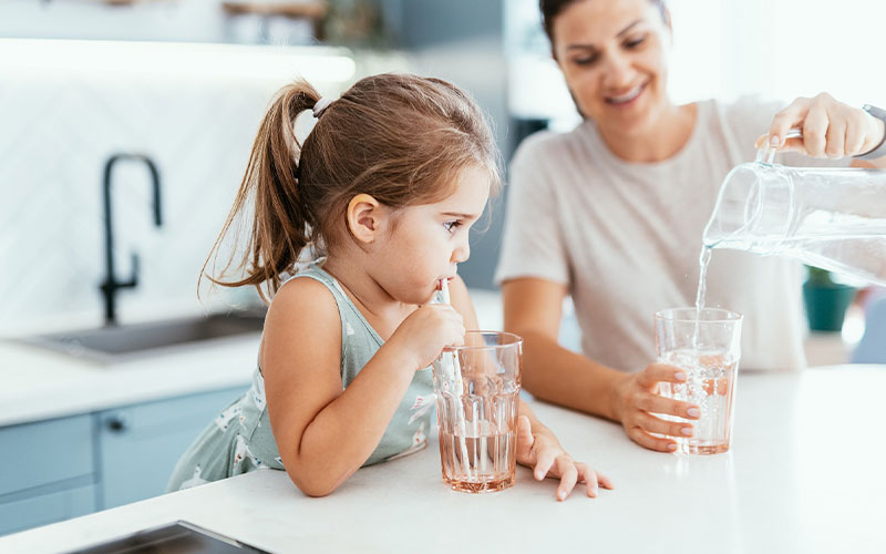 A family pouring and drinking tap water