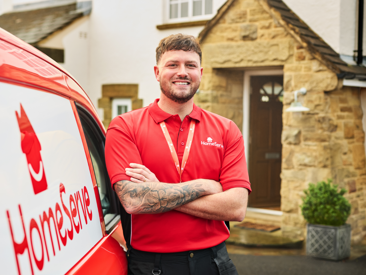 HomeServe engineer smiling while staying close to a HomeServe van