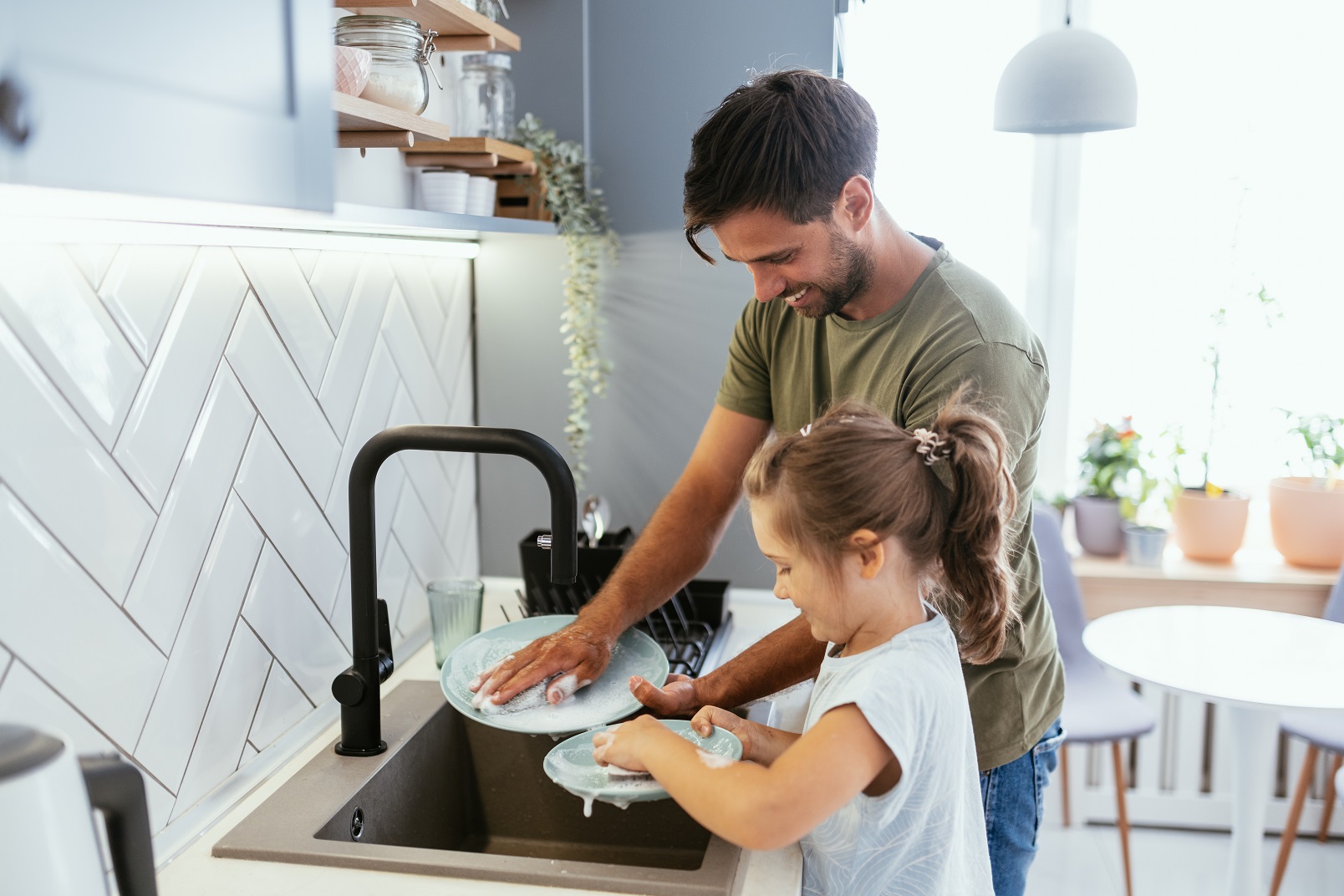 Father and daughter doing the washing up 