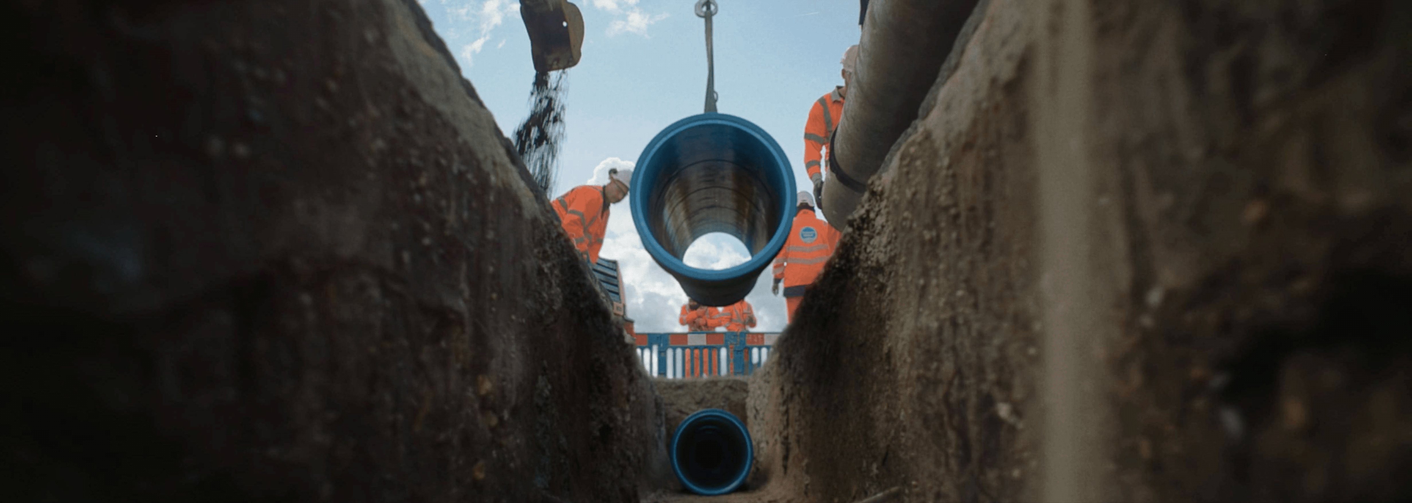 workers fitting a pipe