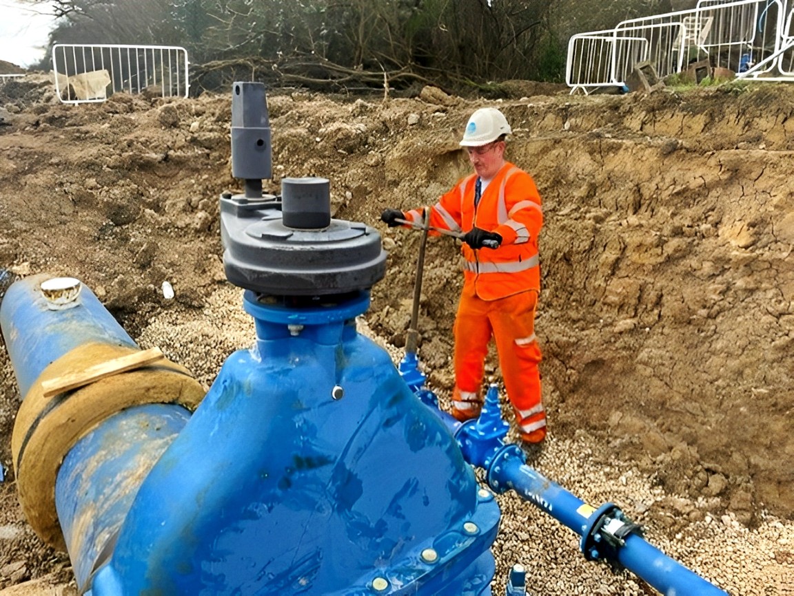 Engineer turning valve on