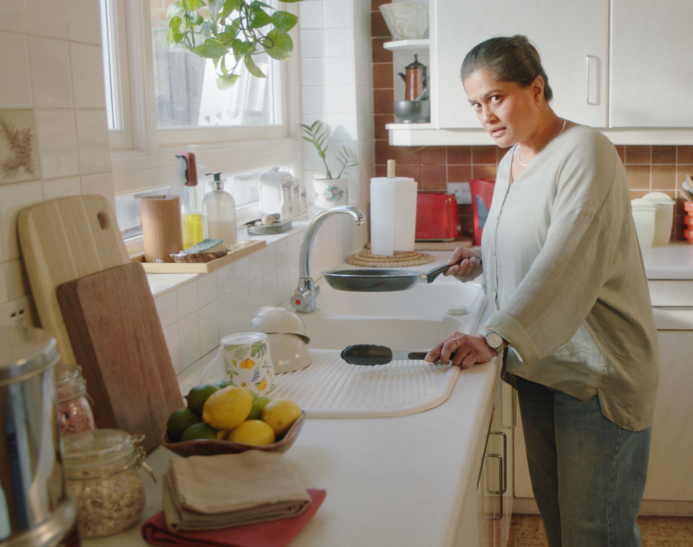 Person washing up a pan