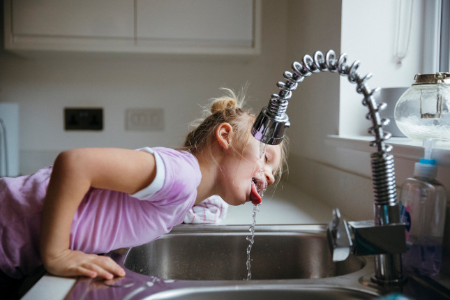 Child drinks straight from the tap